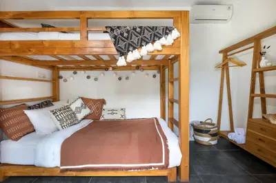 a bedroom with two bunk beds in a room at Unicorn Shelter Villa in Seminyak
