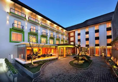 a hotel with a courtyard with a building at Ibis Styles Bali Denpasar in Denpasar