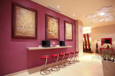 a row of red stools in a waiting room at Ibis Styles Bali Denpasar in Denpasar