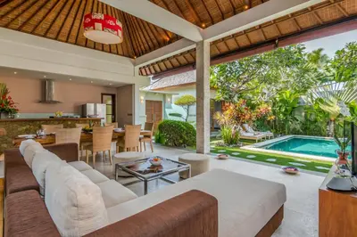 an outdoor living room with a couch and a table at Villa Essence in Seminyak