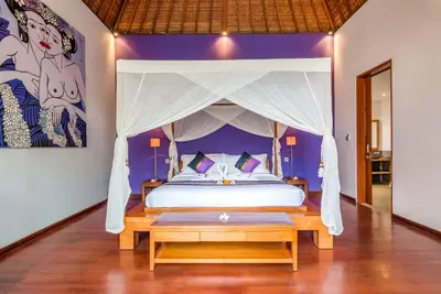 a bedroom with a bed with a canopy at Villa Essence in Seminyak