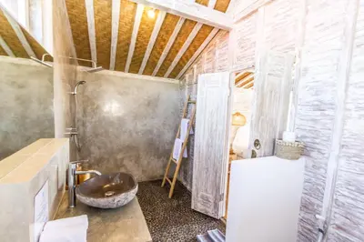 a bathroom with a sink and a wooden ceiling at Villa Opaline by Alfred in Bali in Seminyak