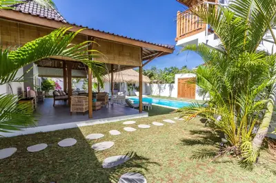 a backyard with a pool and a house at Villa Opaline by Alfred in Bali in Seminyak