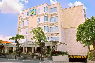 a large white building with a clock on it at Royal Regantris Kuta in Kuta