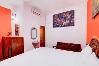 a bedroom with a large bed and a bathroom at Collection O Sanur Near Bali Exotic Marine Park in Sanur