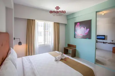 a bedroom with a bed with a stuffed animal on it at Ananta Legian Hotel in Legian