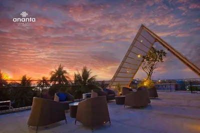 a staircase on top of a building with a sunset at Ananta Legian Hotel in Legian