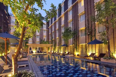 an exterior view of a hotel with a swimming pool at Ananta Legian Hotel in Legian