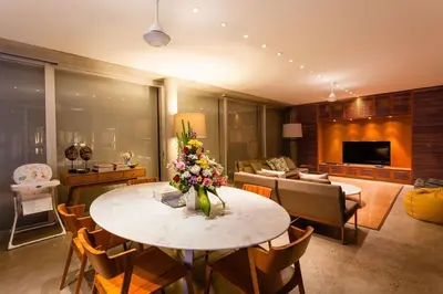 a living room with a table with flowers on it at Villa C88 Seminyak in Seminyak