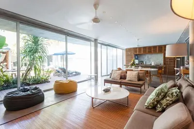a living room with a couch and a table at Villa C88 Seminyak in Seminyak