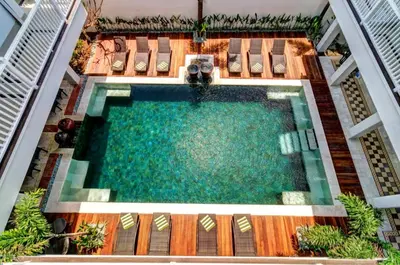an overhead view of a swimming pool in a building at Samsara Inn in Legian