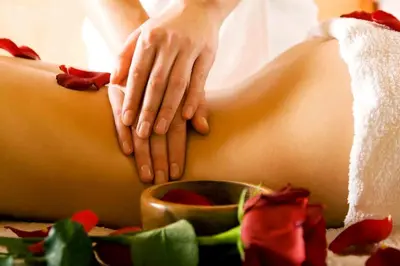 a woman laying on her stomach with her hands on it at Samsara Inn in Legian