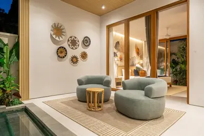 two chairs and a table in a room at Villa Esa Seminyak in Seminyak