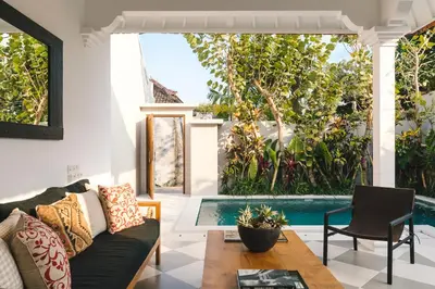 a living room with a couch and a pool at Villa Luma in Seminyak