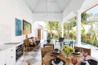 a kitchen and living room with a table and chairs at Villa Luma in Seminyak