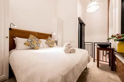 a bedroom with a large white bed with pillows at Central 1 Bedroom Villa 5 Min walk to Seminyak Beach in Seminyak