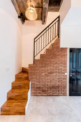 a brick staircase in a house with a blue door at Central 1 Bedroom Villa 5 Min walk to Seminyak Beach in Seminyak