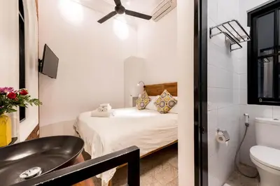 a small bathroom with a bed and a sink at Central 1 Bedroom Villa 5 Min walk to Seminyak Beach in Seminyak