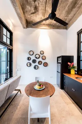 a kitchen with a table and a couch at Central 1 Bedroom Villa 5 Min walk to Seminyak Beach in Seminyak