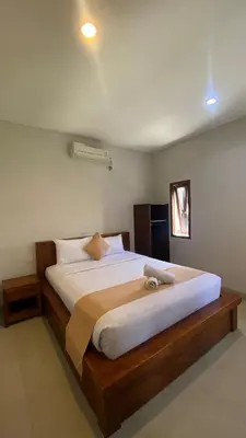 a bedroom with a large bed in a room at Surya Inn in Kuta