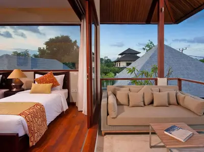 a bedroom with a couch and a bed and a window at Villa Joss Seminyak by Nagisa Bali in Seminyak