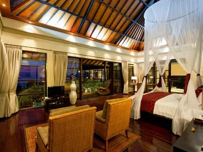 a bedroom with a bed and a desk and a chair at Villa LeGa in Seminyak