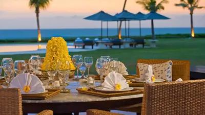 a table with glasses and napkins on top of it at Villa Atas Ombak in Seminyak