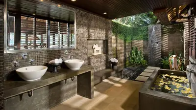 a bathroom with two sinks and a fish tank at Villa Atas Ombak in Seminyak