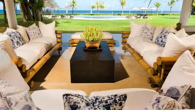 a living room with couches and a table at Villa Atas Ombak in Seminyak