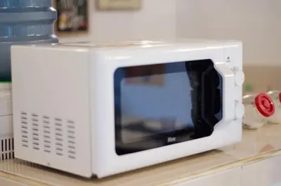 a white microwave oven sitting on top of a counter at Villa Salya - 3BR - Private Pool - 1min walk to La Favela! in Seminyak