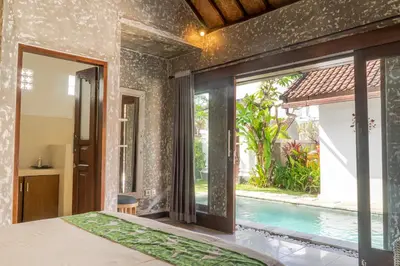 a bedroom with a view of a swimming pool at Villa Salya - 3BR - Private Pool - 1min walk to La Favela! in Seminyak
