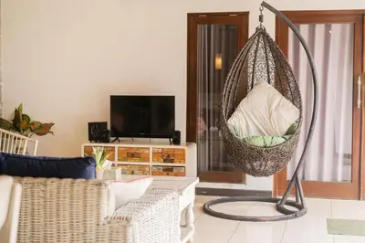 a living room with a hanging hammock at Villa Salya - 3BR - Private Pool - 1min walk to La Favela! in Seminyak