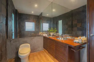 a bathroom with two sinks and a toilet in it at Villa Nara - Your Unique & Private Villa in Seminyak Petitenget in Seminyak