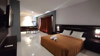 a hotel room with a bed with a towel on it at Gempita House Legian Bali in Legian