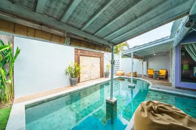 an indoor swimming pool in a house with a patio at Villa West - Charming 2 bdr villa in Oberoi - PERFECT LOCATION! in Seminyak