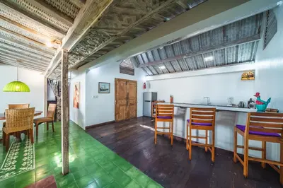 a kitchen and dining room with wooden tables and chairs at Villa West - Charming 2 bdr villa in Oberoi - PERFECT LOCATION! in Seminyak