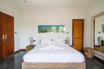 a bedroom with a white bed with a white bow on it at Villa Martine - Fantastic 5BR Villa - Perfect Location in Seminyak in Seminyak