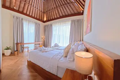 a bedroom with a large bed in a room with windows at NEW 2BR Minica Villa in the heart of Kayu Aya, Oberoi, Seminyak walking distance to Beach, Shops, Restaurants in Seminyak