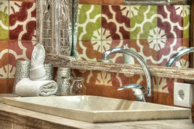 a bathroom sink with a mirror and a towel at Villa Layla - Charming 2BR Villa in Oberoi - Prime Location! in Seminyak