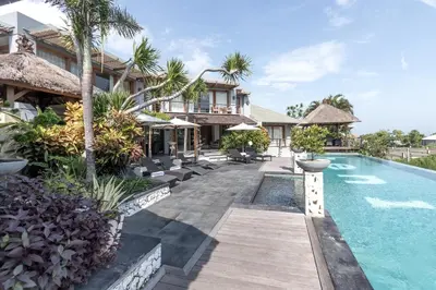 a villa with a swimming pool and a resort at Villa Hening Jimbaran in Jimbaran
