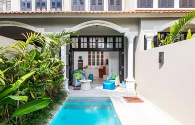 a villa with a swimming pool and a house at Villa Neno in Seminyak