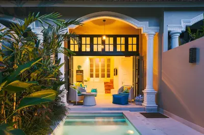 a house with a swimming pool in a yard at Villa Neno in Seminyak
