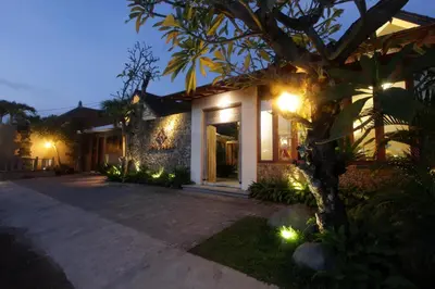 a house with lights on the side of it at Uma Karan in Seminyak