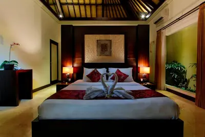 a bedroom with a bed with a towel on it at RC Villas and Spa Bali in Seminyak