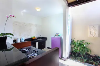 a kitchen with a stove and a purple refrigerator at RC Villas and Spa Bali in Seminyak