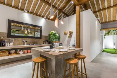 a kitchen with a large island with bar stools at Villa soul in Seminyak