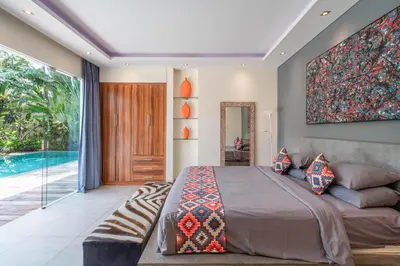 a bedroom with a large bed and a swimming pool at Villa Sawah - 3bd in Seminyak Center in Seminyak