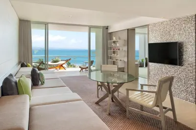 a living room with a couch and a glass table at W Bali - Seminyak in Seminyak