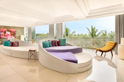 a living room with two chairs and a couch at W Bali - Seminyak in Seminyak