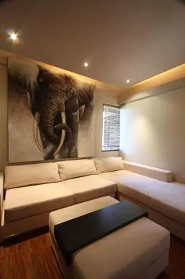 a living room with a couch and an elephant painting at Sejuk Suites in Legian